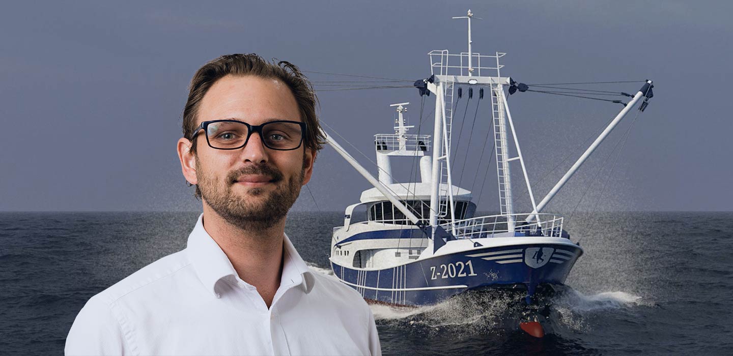 lead naval architect Geoffrey Smits in front of fishing vessel