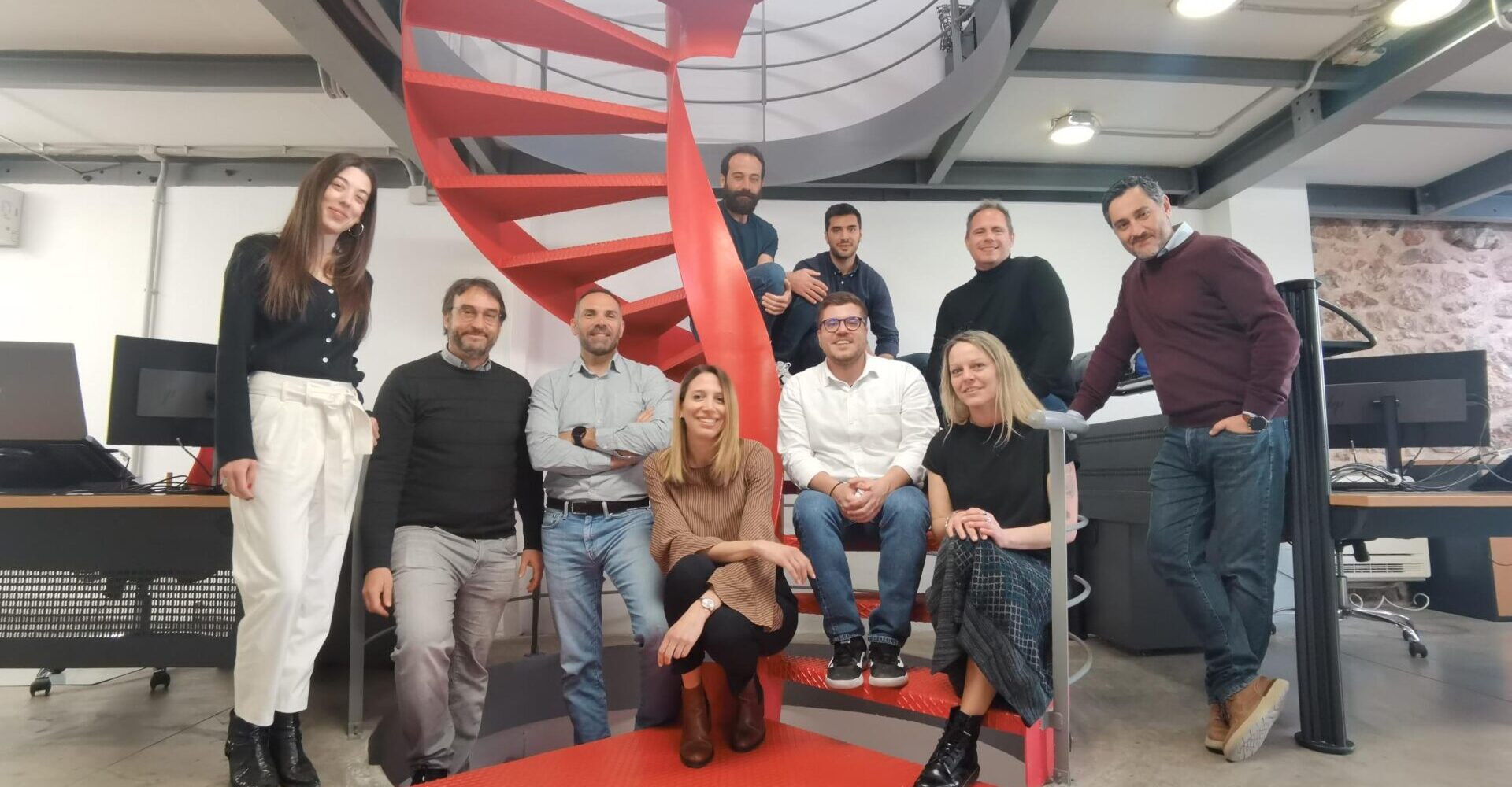 C-Job Athens colleague group photo on spiral staircase